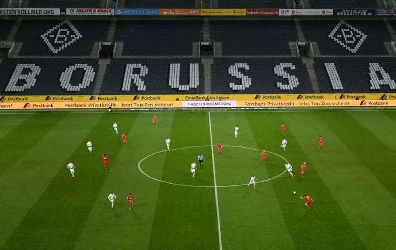 An overview shows the empty stadium during the German first division Bundesliga football match Borussia Moenchengladbach v 1 FC Cologne in Moenchengladbach, western Germany on March 11, 2020. - Rhine Bundesliga derby between Borussia Moenchengladbach and Cologne, will be held behind closed doors due to the coronavirus, the first game in Bundesliga history to be played without fans. (Photo by Ina FASSBENDER / AFP) / DFL REGULATIONS PROHIBIT ANY USE OF PHOTOGRAPHS AS IMAGE SEQUENCES AND/OR QUASI-VIDEO