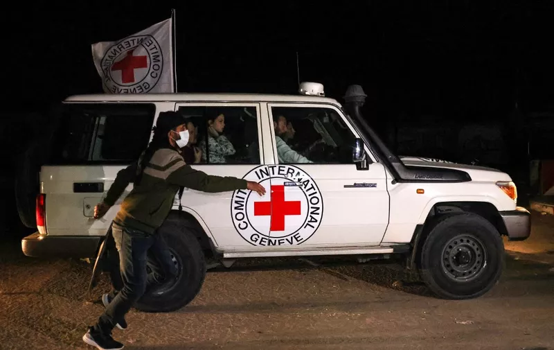 An International Red Cross vehicle reportedly carrying hostages released by Hamas drives towards the Rafah border point with Egypt ahead of their transfer to Israel on November 25, 2023. A group of 13 Israeli and four Thai hostages released by Hamas crossed into Egypt late Saturday, Egyptian state-linked television reported. (Photo by SAID KHATIB / AFP)