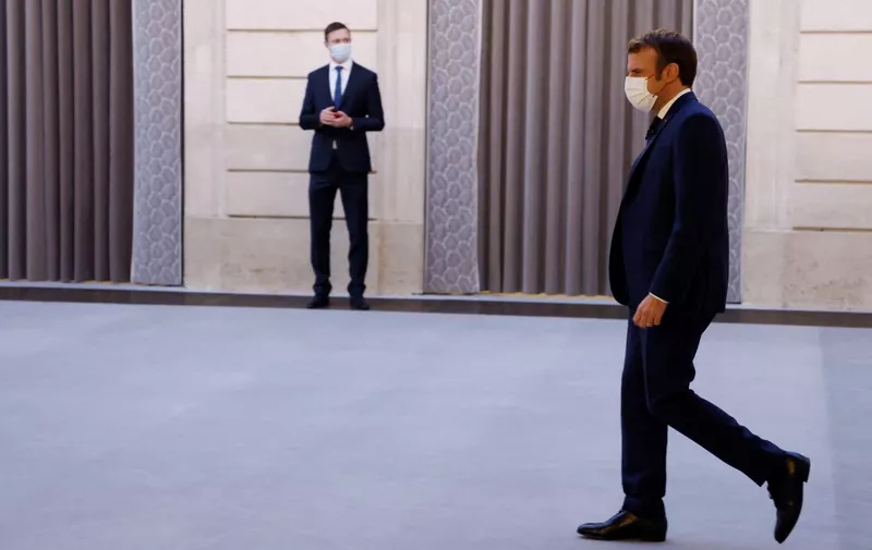French President Emmanuel Macron arrives for a press conference on France assuming EU presidency, in Paris, on December 9, 2021. (Photo by various sources / AFP)