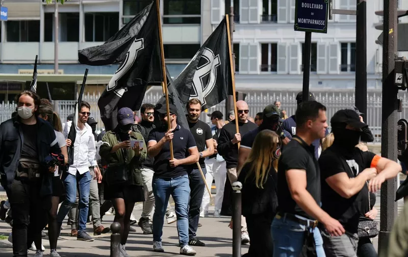 Members of far-right group "Comite du 9 Mai" (C9M- Committee of May 9) take part in a demonstration to commemorate the 30th anniversary of the death of Sebastien Deyzieu of the "Oeuvre Francaise" ultranationalist group, during a rally in Paris, on May 11, 2024. Deyzieu died after suffering a fall while being pursued by police following a far-right demonstration in Paris in 1994. (Photo by Dimitar DILKOFF / AFP)