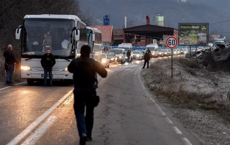 Buses and cars with Kosovo Serbs queue outside the town of Leposavic, northern Kosovo, bordering Serbia, on December 17, 2023, during parliamentary and local elections in Serbia. Hundreds of ethnic Serbs on December 17, 2023 travelled to southern Serbia to cast their votes in the Serbian legislative elections as Pristina and Belgrade failed to reach an agreement that would enable them to do so in Kosovo itself. (Photo by STRINGER / AFP)