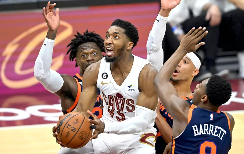 Apr 15, 2023; Cleveland, Ohio, USA; Cleveland Cavaliers guard Donovan Mitchell (45) drives through a trio of New York Knicks defenders in the second quarter of game one of the 2023 NBA playoffs at Rocket Mortgage FieldHouse. Mandatory Credit: David Richard-USA TODAY Sports