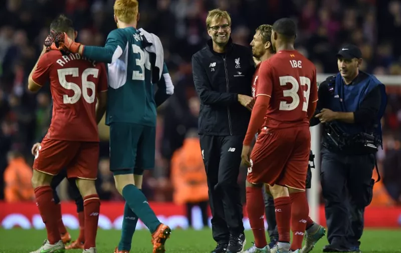 Liverpool's German manager Jurgen Klopp (C) shares a moment with Liverpool's Brazilian midfielder Lucas Leiva (3R) and Liverpool's English midfielder Jordon Ibe (2R) following the English League Cup fourth round football match between Liverpool and Bournemouth at Anfield stadium in Liverpool, north west England on October 28, 2015. Liverpool won the match 1-0.  AFP PHOTO / PAUL ELLIS

RESTRICTED TO EDITORIAL USE. NO USE WITH UNAUTHORIZED AUDIO, VIDEO, DATA, FIXTURE LISTS, CLUB/LEAGUE LOGOS OR 'LIVE' SERVICES. ONLINE IN-MATCH USE LIMITED TO 75 IMAGES, NO VIDEO EMULATION. NO USE IN BETTING, GAMES OR SINGLE CLUB/LEAGUE/PLAYER PUBLICATIONS.