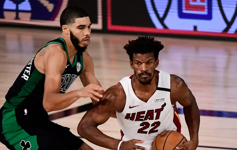 LAKE BUENA VISTA, FLORIDA - SEPTEMBER 15: Jimmy Butler #22 of the Miami Heat drives the ball against Jayson Tatum #0 of the Boston Celtics during the fourth quarter in Game One of the Eastern Conference Finals during the 2020 NBA Playoffs at The Field House at the ESPN Wide World Of Sports Complex on September 15, 2020 in Lake Buena Vista, Florida. NOTE TO USER: User expressly acknowledges and agrees that, by downloading and or using this photograph, User is consenting to the terms and conditions of the Getty Images License Agreement.  (Photo by Douglas P. DeFelice/Getty Images)