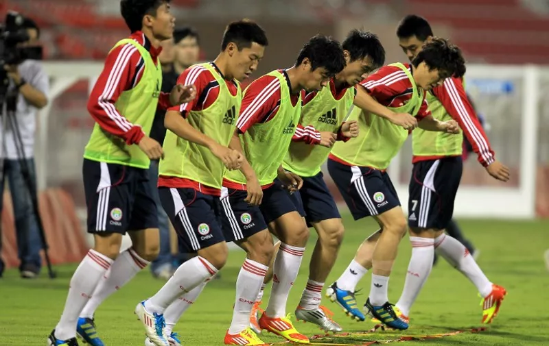 China's national football team takes part in a training session in Doha on November 10, 2011. China will play against Iraq in an Asian qualifying match for the 2014 World Cup on November 11. AFP PHOTO/KARIM JAAFAR / AFP PHOTO / KARIM JAAFAR