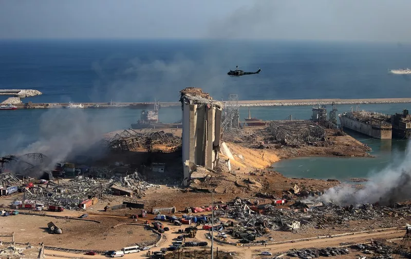 A general view shows the damaged grain silos of Beirut's harbour and its surroundings on August 5, 2020, one day after a powerful twin explosion tore through Lebanon's capital, resulting from the ignition of a huge depot of ammonium nitrate at the city's main port. - Rescuers searched for survivors in Beirut after a cataclysmic explosion at the port sowed devastation across entire neighbourhoods, killing more than 100 people, wounding thousands and plunging Lebanon deeper into crisis. The blast, which appeared to have been caused by a fire igniting 2,750 tonnes of ammonium nitrate left unsecured in a warehouse, was felt as far away as Cyprus, some 150 miles (240 kilometres) to the northwest. (Photo by STR / AFP)