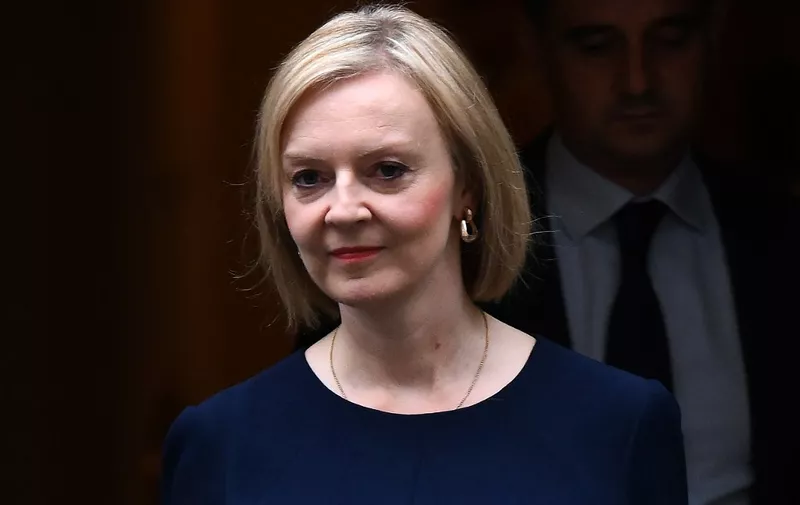 (FILES) In this file photo taken on September 23, 2022 Britain's Prime Minister Liz Truss walks out of Number 10 Downing Street on her way to the House of Commons for the government's anti-inflation budget plan in London. - UK Prime Minister Liz Truss on September 29, 2022 defended her tax cuts policy, despite it triggering market turmoil and forcing a Bank of England intervention to prevent "material risk" to the economy. "We had to take urgent action to get our economy growing, get Britain moving, and also deal with inflation," she told local station BBC Radio Leeds in her first comments since Friday's mini-budget. (Photo by Daniel LEAL / AFP)