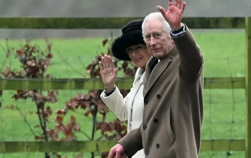 Britain's King Charles III and Britain's Queen Camilla waves as they leave after attending a service at St Mary Magdalene Church on the Sandringham Estate in eastern England on February 11, 2024. Britain's King Charles III on Saturday expressed his "heartfelt thanks" to well-wishers, in his first statement since his shock announcement that he has cancer. (Photo by JUSTIN TALLIS / AFP)