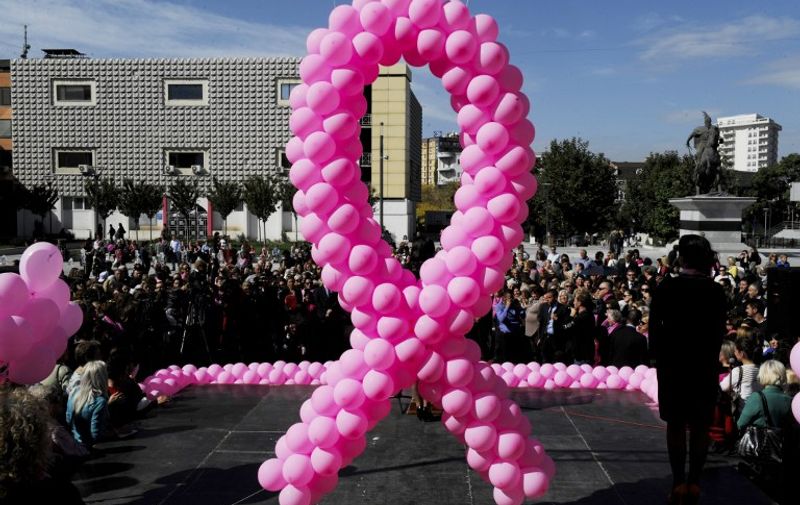 Pink balloons hang on a stage during an event to raise awareness on breast cancer in Pristina on October 12, 2013 . AFP PHOTO / ARMEND NIMANI / AFP PHOTO / ARMEND NIMANI