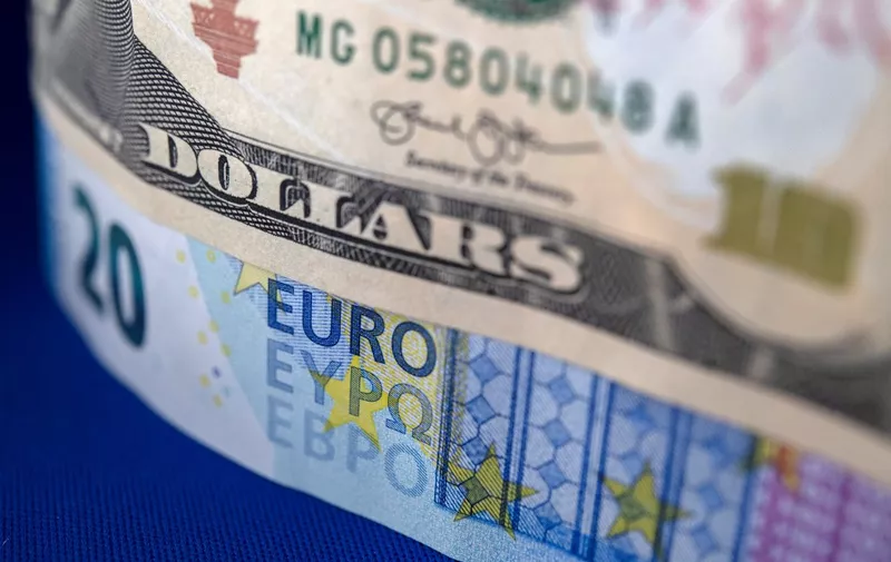 US dollars and Euro bills are pictured on September 6, 2022 in Brest, western France. The euro sunk below $0.99 on September 5, 2022 a 20-year-low, following the announcement the previous week that Russia would cut off gas deliveries to Germany via the Nord Stream pipeline. (Photo by FRED TANNEAU / AFP)
