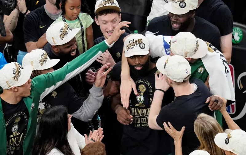Boston Celtics teammates congratulate Jaylen Brown, center right, after he was named MVP after the Celtics defeated the Dallas Mavericks in Game 5 of the NBA basketball finals, Monday, June 17, 2024, in Boston. (AP Photo/Michael Dwyer)