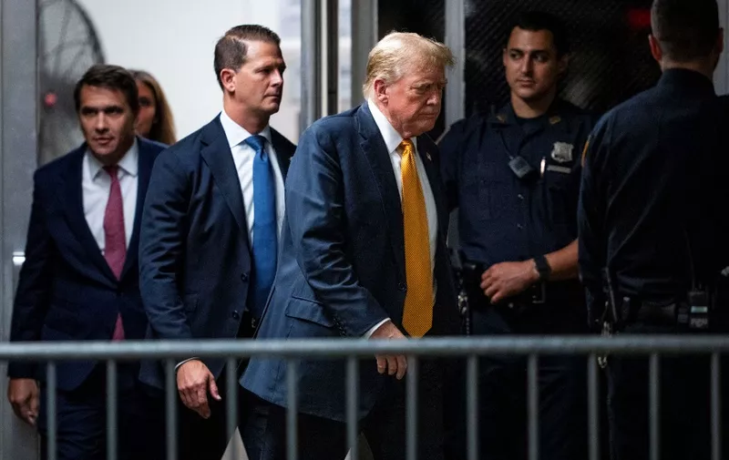 Former US President and Republican presidential candidate Donald Trump walks to the courtroom during his criminal trial at Manhattan Criminal Court in New York City on May 29, 2024. Jurors began deliberating Wednesday on whether to convict Donald Trump in the first criminal trial of a former US president -- with their decision potentially upending November's election, in which the Republican seeks to return to power. (Photo by Doug Mills / POOL / AFP)