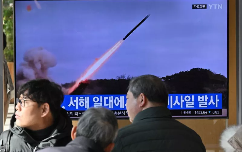 People watch a television screen showing a news broadcast with file footage of a North Korean missile test, at a railway station in Seoul on January 24, 2024. North Korea fired several cruise missiles towards the Yellow Sea on January 24, Seoul's military said, the latest in a series of tension-raising moves by the nuclear-armed state. (Photo by Jung Yeon-je / AFP)