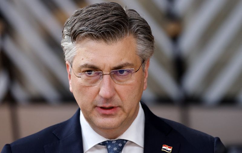 Croatia's Prime Minister Andrej Plenkovic talks to the press as he arrives for the second day of a European Union (EU) summit at the EU Headquarters, in Brussels on March 25, 2022. (Photo by Ludovic MARIN / AFP)
