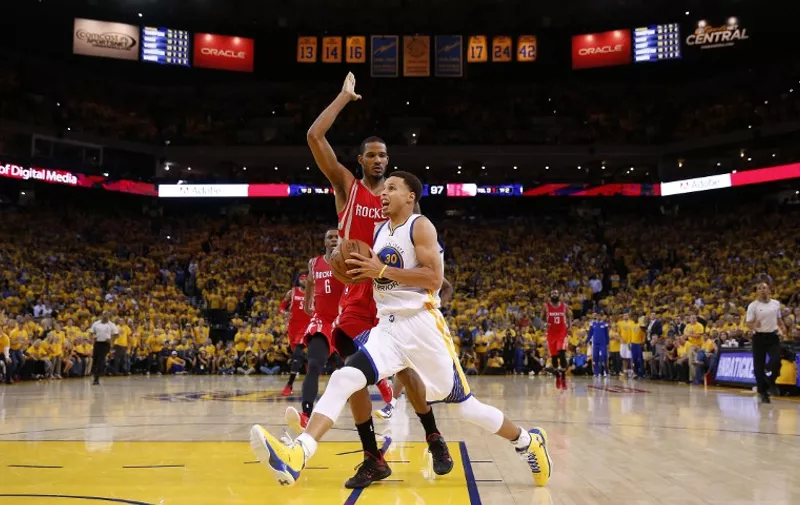 OAKLAND, CA - MAY 19: Stephen Curry #30 of the Golden State Warriors drives against Trevor Ariza #1 of the Houston Rockets in the fourth quarter during Game One of the Western Conference Finals of the 2015 NBA Playoffs at ORACLE Arena on May 19, 2015 in Oakland, California. NOTE TO USER: User expressly acknowledges and agrees that, by downloading and or using this photograph, user is consenting to the terms and conditions of Getty Images License Agreement.   Ezra Shaw/Getty Images/AFP
