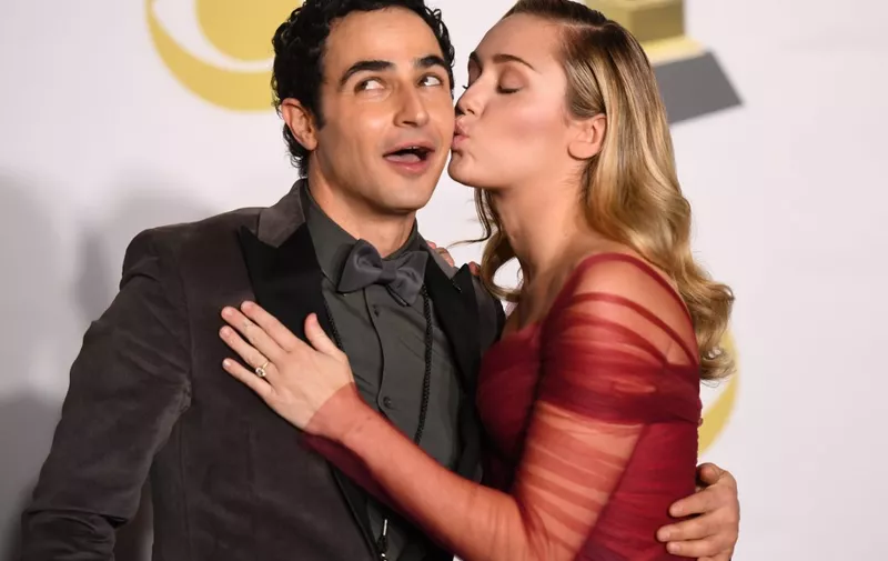 Fashion designer Zac Posen (L) and singer Miley Cyrus pose in the press room during the 60th Annual Grammy Awards on January 28, 2018, in New York. (Photo by Don EMMERT / AFP)