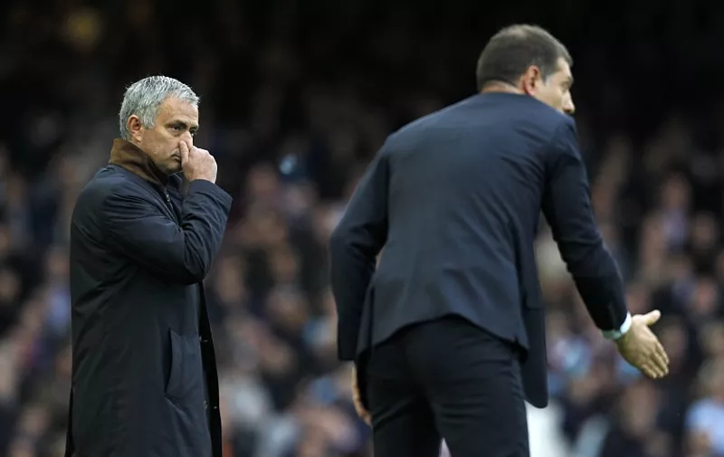 Chelsea's Portuguese manager Jose Mourinho (L) gestures as West Ham United's Croatian manager Slaven Bilic instructs his team during the English Premier League football match between West Ham United and Chelsea at The Boleyn Ground in Upton Park, east London on October 24, 2015. AFP PHOTO / IAN KINGTON

RESTRICTED TO EDITORIAL USE. No use with unauthorized audio, video, data, fixture lists, club/league logos or 'live' services. Online in-match use limited to 75 images, no video emulation. No use in betting, games or single club/league/player publications.