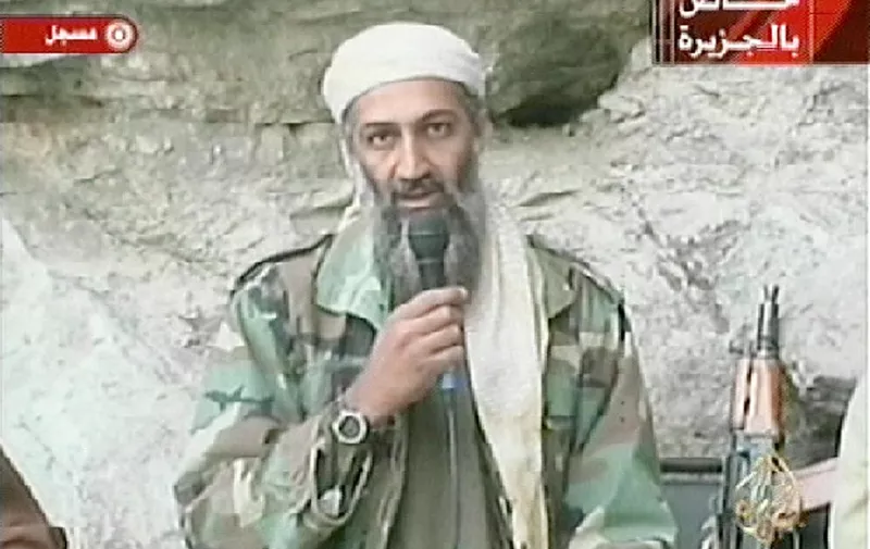 Saudi-born alleged terror mastermind Osama bin Laden is seen in this video footage recorded "very recently" at an undisclosed location in Afghanistan aired by the Qatar-based satelite TV station al-Jazeera 07 October 2001. Retaliatory strikes against Afghanistan began 07 October with US and British forces bombing terrorist camps, air bases and air defense installations in the first stage of its campaign against the Taliban regime for sheltering bin Laden, who is the "prime suspect" in the 11 September attacks in the US. Al-Jazeera reported that the video was shot to be broadcast after the first US bombings.     AFP PHOTO/AL-JAZEERA (Photo by AL-JAZEERA / AFP)
