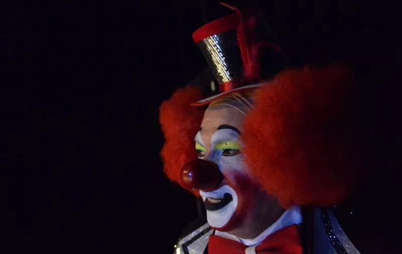 A clown remains on the stage during the second day of the XXI Convention of Clowns, at the Jimenez Rueda Theatre, in Mexico City on October 18, 2016. 
Latin American clowns hold their 21st annual conference in Mexico City from October 17 through 20. The lurking clown phenomenon as a wave of hysteria about sightings of "creepy" or "killer" clowns that sweeps the United States and European nations will be discussed. / AFP PHOTO / PEDRO PARDO