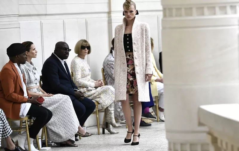 Global Editorial Director of Vogue of Vogue Anna Wintour (C) and British Vogue Editor-in-Chief and European Editorial Director of Vogue Edward Enninful Obe (3rd L) watch a model as she presents a creation for Chanel during the Women's Fall-Winter 2021/2022 Haute Couture collection fashion show at the Palais Galliera in Paris, on July 6, 2021. (Photo by STEPHANE DE SAKUTIN / AFP) / The erroneous mention[s] appearing in the metadata of this photo by STEPHANE DE SAKUTIN has been modified in AFP systems in the following manner: [British Vogue Editor-in-Chief and European Editorial Director of Vogue Edward Enninful Obe] instead of [American editor-at-large of Vogue magazine Andre Talley]. Please immediately remove the erroneous mention[s] from all your online services and delete it (them) from your servers. If you have been authorized by AFP to distribute it (them) to third parties, please ensure that the same actions are carried out by them. Failure to promptly comply with these instructions will entail liability on your part for any continued or post notification usage. Therefore we thank you very much for all your attention and prompt action. We are sorry for the inconvenience this notification may cause and remain at your disposal for any further information you may require.