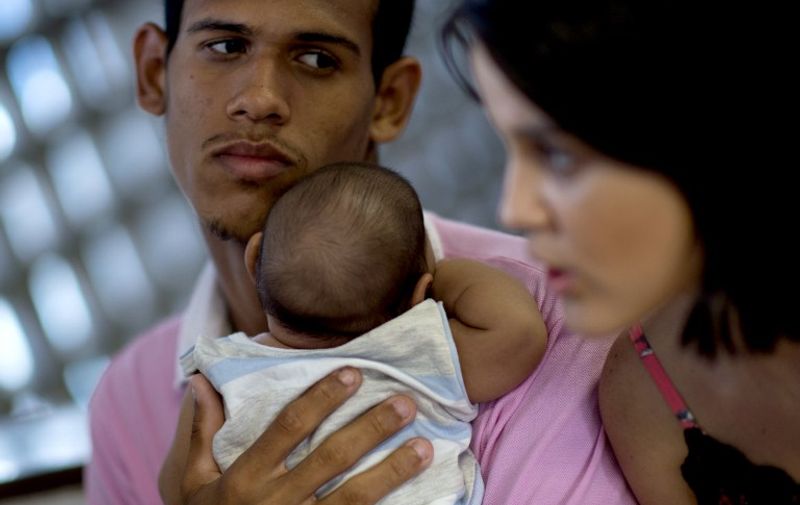 Matheus Lima,22, and Kleisse Marcelina,24, tend their two-month-old son Pietro suffering from microcephalia caught through an Aedes aegypti mosquito bite, at the Obras Sociais Irma Dulce hospital in Salvador, Brazil on January 27, 2016. AFP PHOTO / Christophe SIMON / AFP / CHRISTOPHE SIMON