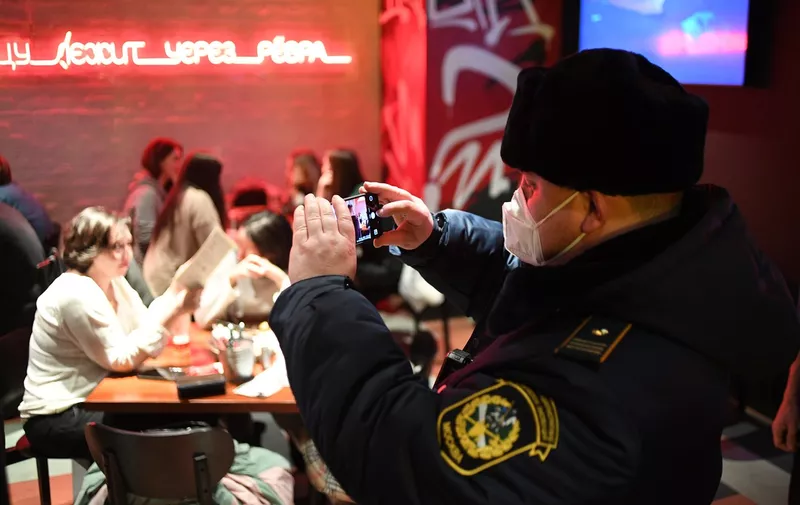 6750930 29.01.2022 A police officer takes photos during a raid to identify violations of sanitary and epidemiological restrictions at a cafe amid the coronavirus disease outbreak, in Moscow, Russia.,Image: 657650364, License: Rights-managed, Restrictions: Editors' note: THIS IMAGE IS PROVIDED BY RUSSIAN STATE-OWNED AGENCY SPUTNIK., Model Release: no, Credit line: Profimedia