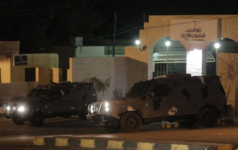 Jordanian police vehicles guard the municipality building in the city of Karak, on February 3, 2015, after the Islamic State group released a video purportedly showing Jordanian pilot First Lieutenant Maaz al-Kassasbeh, 26-year-old, being burned alive in a cage, in the jihadists' most brutal execution yet of a foreign hostage. Kassasbeh, who hails from a town near Karak, was captured on December 24 after his F-16 jet crashed during a mission over northern Syria as part of the US-led campaign against the jihadists. Jordan will execute on February 4, 2015, an Iraqi woman Sajida al-Rishawi on death row over a failed bombing after having vowed to avenge the murder of a Jordanian pilot by Islamic State jihadists, an official said. AFP PHOTO/KHALIL MAZRAAWI / AFP PHOTO / KHALIL MAZRAAWI