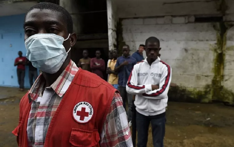 Liberian Red Cross staff looks for dead people in Monrovia on October 3, 2014, where the Ebola virus has crippled the country's already weak health services, killing 89 health workers, and its spiral out of control has prompted stark warnings of an explosion of cases and complete collapse of the fragile post-war society. Liberia has accounted for more than half of Ebola deaths, with the official toll rising to 3,338 on October 1, according to the World Health Organization (WHO).
AFP PHOTO / PASCAL GUYOT / AFP PHOTO / PASCAL GUYOT