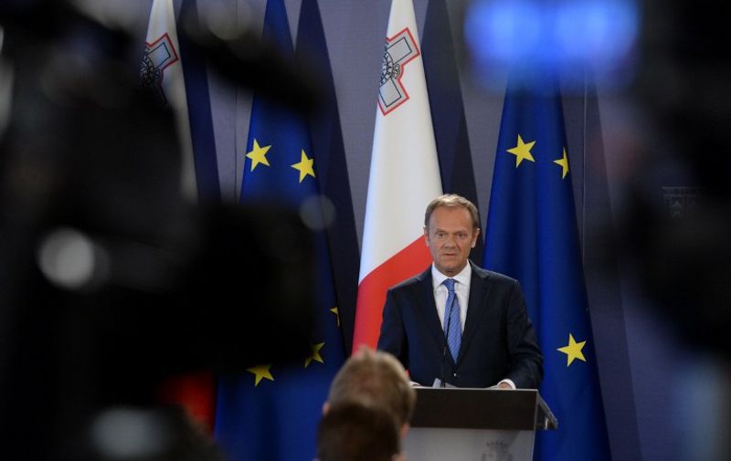 The President of the European Council Donald Tusk (L) speaks during a press conference on March 31, 2017 in St Julians Malta. The European Union demanded that Britain make "sufficient progress" on its divorce before talks on a trade deal can start as it laid out its tough Brexit negotiating plans today.  / AFP PHOTO / Matthew Mirabelli / Malta OUT