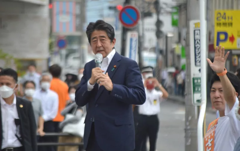 Japanese former Shinzo Abe speaks for his party member candidate of the House of Councillors election near Yamato Saidaiji Station in Nara Prefecture on July 8, 2022, just seconds before he is shot.    67-year-old Abe has reportedly been shot in the chest and he has been in a state of cardio-respiratory arrest. ( The Yomiuri Shimbun ) (Photo by Kazuhiko Hirano / Yomiuri / The Yomiuri Shimbun via AFP)
