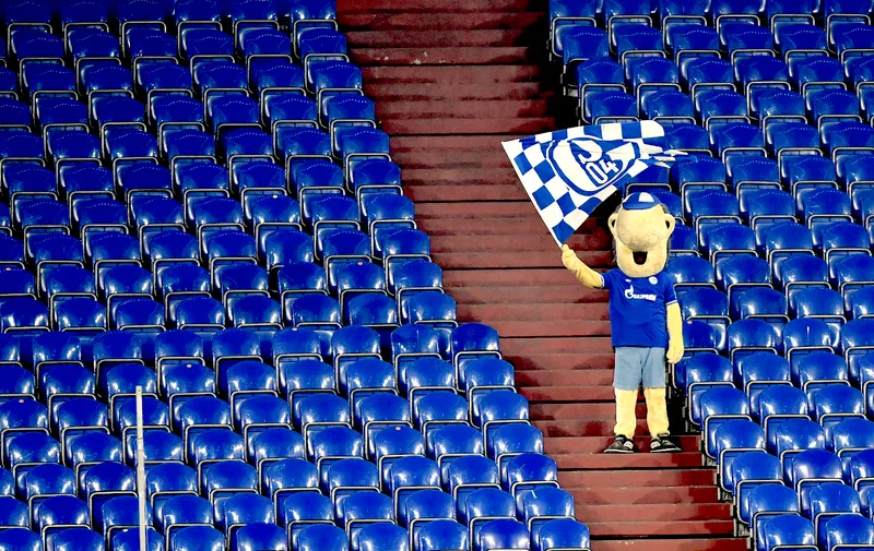 Schalke mascot Erwin waves a team flag from the stands during the German Bundesliga soccer match between FC Schalke 04 and Borussia Dortmund in Gelsenkirchen, Germany, Saturday, Feb. 20, 2021. (AP Photo/Martin Meissner, Pool)