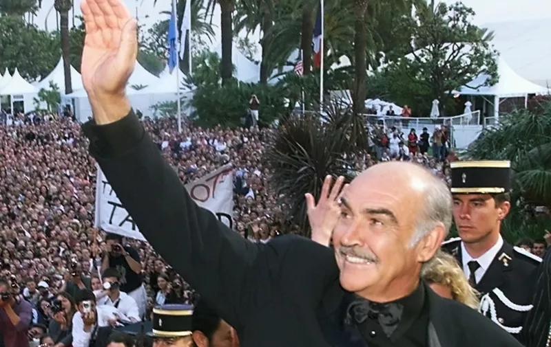 (FILES) In this file photo taken on May 14, 1999 British actor Sean Connery waves to the crowd on the steps of the Palais des Festivals before the screening of their movie "Entrapment" in selection for the 52nd Cannes Film Festival. - Legendary British actor Sean Connery, best known for playing fictional spy James Bond in seven films, has died aged 90, his family told the BBC on on October 31, 2020. The Scottish actor, who was knighted in 2000, won numerous awards during his decades-spanning career, including an Oscar, three Golden Globes and two Bafta awards. (Photo by Christophe SIMON / AFP)
