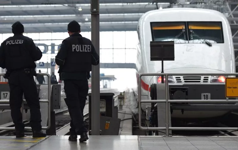 Police officers patrol in front of a train in front of a train at the main train station in Munich, southern Germany, on January 1, 2016.
German police lifted an alert of an imminent attack in Munich, hours after two key train stations were evacuated over fears that a New Year suicide bomb assault was being planned. / AFP / Christof STACHE