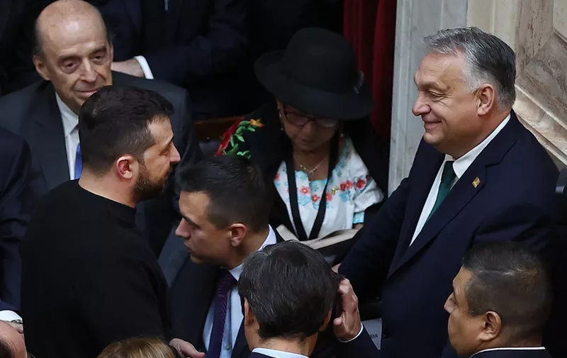 Ukraine's President Volodymyr Zelensky (L) chats with Hungary's Prime Minister Viktor Orban (R) during the inauguration of Argentina's new president Javier Milei at the Congress in Buenos Aires on December 10, 2023. Libertarian economist Javier Milei was sworn in Sunday as Argentina's president, after a resounding election victory fuelled by fury over the country's economic crisis. (Photo by ALEJANDRO PAGNI / AFP)