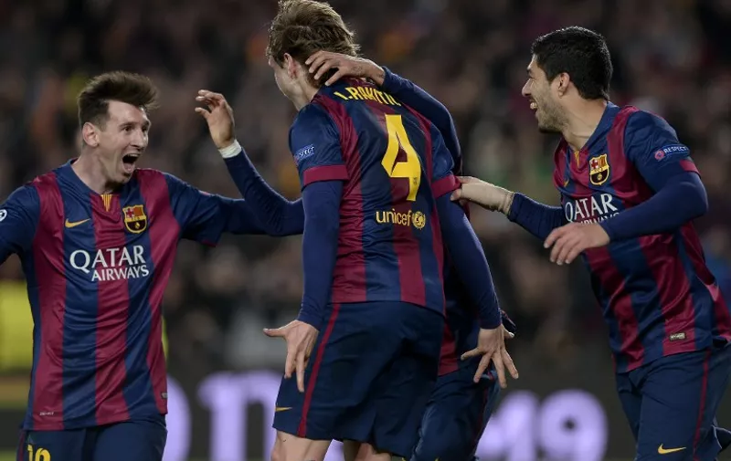 Barcelona's Croatian midfielder Ivan Rakitic (C) is congratulated by his teammate Barcelona's Argentinian forward Lionel Messi  (L) after scoring during the UEFA Champions League round of 16 football match FC Barcelona vs Manchester City at the Camp Nou stadium in Barcelona on March 18, 2015. AFP PHOTO/ JOSEP LAGO / AFP / JOSEP LAGO