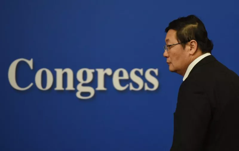 Chinese Finance Minister Lou Jiwei arrives for a National People's Congress press conference in Beijing on March 7, 2016. 
China's labour contract law harms workers and must become more flexible, Lou said on March 7, as China seeks to transform the structure of its economy while maintaining  employment.  / AFP PHOTO / GREG BAKER