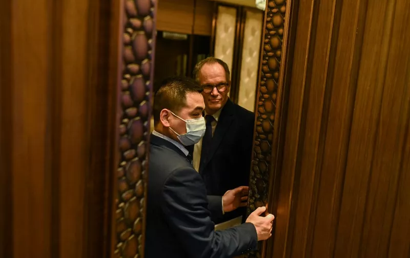 Peter Ben Embarek (R) leaves a press conference after wrapping up a visit by the international team of experts from the World Health Organization (WHO) in the city of Wuhan in China's Hubei province on February 9, 2021. (Photo by Hector RETAMAL / AFP)