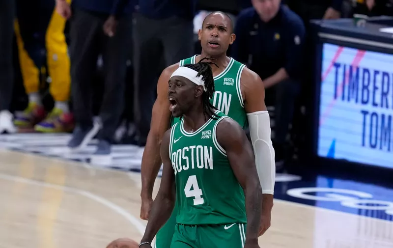 Boston Celtics guard Jrue Holiday (4) celebrates with teammate center Al Horford, rear, during the second half of Game 3 of the NBA Eastern Conference basketball finals against the Indiana Pacers, Saturday, May 25, 2024, in Indianapolis. The Celtics won 114-111.(AP Photo/Darron Cummings)