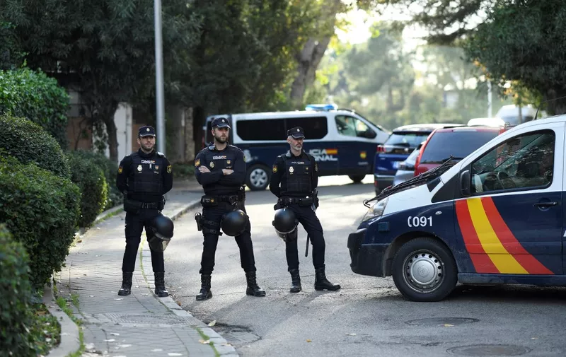 Spanish policemen block the street after a letter bomb explosion at the Ukraine's embassy in Madrid on November 30, 2022. - An employee of Ukraine's embassy in Madrid was "lightly" injured on November 30 when a letter bomb blew up as he handled it, a police source said. (Photo by OSCAR DEL POZO / AFP)