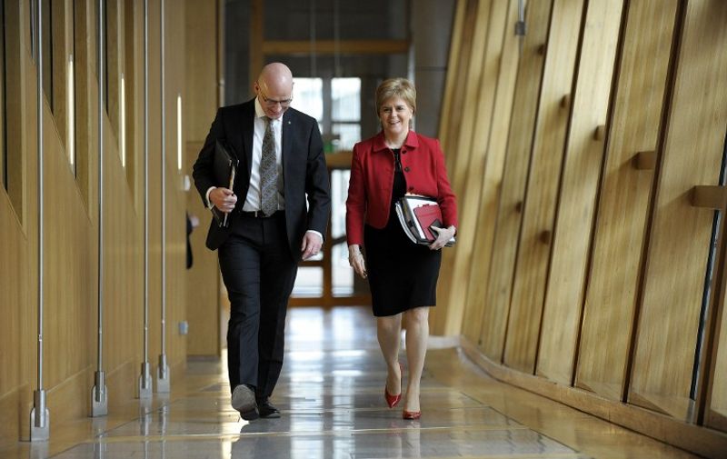 Scotland's First Minister Nicola Sturgeon (R) and Deputy First Minister John Swinney arrive to attend the second day of the 'Scotland's Choice' debate on a motion to seek the authority to hold an indpendence referendum at the Scottish Parliament in Edinburgh on March 28, 2017.
The vote in Scotland's parliament on supporting First Minister Nicola Sturgeon's call for a new independence referendum resumed Tuesday, aftering beit was delayed in a gesture of respect following the March 22 attack on the British parliament. / AFP PHOTO / Andy Buchanan