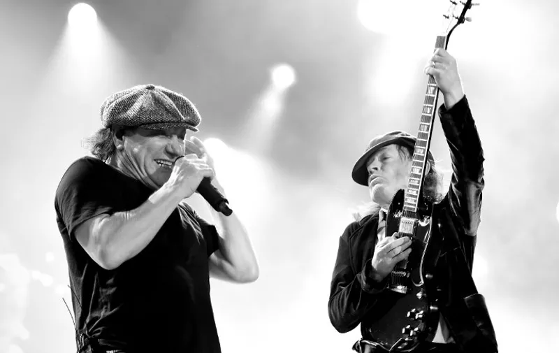 LOS ANGELES, CA - SEPTEMBER 28: (EDITORS NOTE: Image was digitally converted to black and white.) Singer Brian Johnson (L) and musician Angus Young of AC/DC perform at Dodger Stadium on September 28, 2015 in Los Angeles, California.   Kevin Winter/Getty Images/AFP