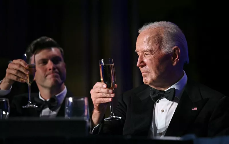 US President Joe Biden toasts with US comedian Colin Jost during the White House Correspondents' Association (WHCA) dinner at the Washington Hilton, in Washington, DC, on April 27, 2024. (Photo by Brendan SMIALOWSKI / AFP)