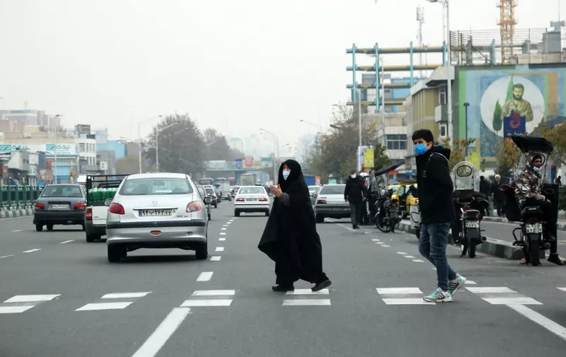 TEHRAN, IRAN - DECEMBER 10: People are seen at the streets as the city turning gray due to the high levels of air pollution in Tehran, Iran on December 10, 2022. All educational institutions shut for two days after air pollution has begun to affect daily life in the country. Tehran is among the top 3 cities in the world's air pollution ranking, therefore educational institutions often suspended. Fatemeh Bahrami / Anadolu Agency (Photo by Fatemeh Bahrami / ANADOLU AGENCY / Anadolu Agency via AFP)