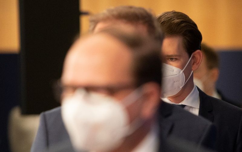 Austrian Chancellor Sebastian Kurz (2nd R), Austria's Health Minister Rudolf Anschober (3rd R) and the President of the Austrian Medical Association Thomas Szekeres (Front), arrive to give a press conference at the Medical University of Vienna, Austria, on December 27, 2020 on the occasion of the Pfizer-BioNTech Covid-19 corona virus vaccine rollout. - The European Union began a vaccine rollout, even as countries in the bloc were forced back into lockdown by a new strain of the virus, believed to be more infectious, that continues to spread from Britain. The pandemic has claimed more than 1.7 million lives and is still running rampant in much of the world, but the recent launching of innoculation campaigns has boosted hopes that 2021 could bring a respite. (Photo by ALEX HALADA / AFP)