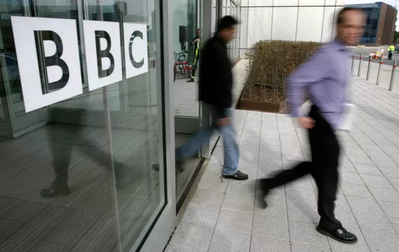 People leave the BBC building, in the corporation's West London headquarters, 21 March 2005. The BBC is to axe 2050 jobs in a second wave of cuts to save hundreds of millions of pounds, the corporation announced 22 March 2005. AFP PHOTO/CARL DE SOUZA (Photo by CARL DE SOUZA / AFP)