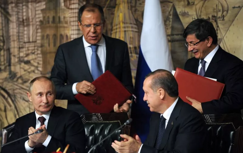 From left: Russian President Viladimir Putin, Russian Foreign Minister Sergei Lavrov, Turkish Prime Minister Recep Tayyip Erdogan and Turkish Foreign Minister Ahmet Davutoglu react on December 3, 2012 after a signing ceremony during a press conference in Istanbul. Putin met Erdogan for talks covering their opposing views on Syria and how to deal with a conflict that has claimed around  41,000 lives since March 2011, according to one monitoring group. Turkey and Russia have growing trade and energy links but they remain at loggerheads over Syria.    AFP PHOTO/BULENT KILIC

 / AFP / BULENT KILIC