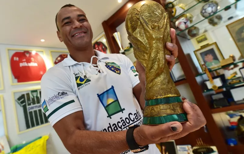TO GO WITH AFP STORY BY NATALIA RAMOS
Former Brazilian national football team captain Cafu holds a replica of the FIFA World Cup trophy during an interview with AFP at his home in Barueri, metropolitan area of Sao Paulo, Brazil on May 29, 2014. AFP PHOTO / NELSON ALMEIDA
