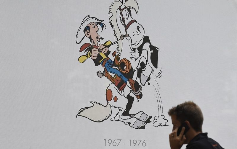 TO GO AFP STORY BY PHILIPPE SIUBERSKI
A man pass by a Lucky Luke comic strip table during the festival "Fete de la BD" in Brussels, on September 2, 2016. - The comic strip festival "Fete de la BD" celebrates this year the booming Quebec cartoon art, and will take place in Brussels from September 2 to Septembre 4, 2016. (Photo by JOHN THYS / AFP) / TO GO WITH AFP STORY BY PHILIPPE SIUBERSKI