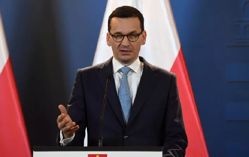 Prime Minister of Poland Mateusz Morawiecki gestures as he gives a joint press conference with the Hungarian Prime Minister (not in picture) at the Hungarian parliament in Budapest on January 3, 2018.
The Polish premier pays his first official visit abroad in Hungary. / AFP PHOTO / Attila KISBENEDEK