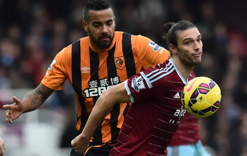 West Ham United's English striker Andy Carroll (R) vies with Hull City's English midfielder Tom Huddlestone (L) during the English Premier League football match between West Ham United and Hull City at the Boleyn Ground, Upton Park, in east London, on January 18, 2015. AFP PHOTO / BEN STANSALL

== RESTRICTED TO EDITORIAL USE. NO USE WITH UNAUTHORIZED AUDIO, VIDEO, DATA, FIXTURE LISTS, CLUB/LEAGUE LOGOS OR LIVE SERVICES. ONLINE IN-MATCH USE LIMITED TO 45 IMAGES, NO VIDEO EMULATION. NO USE IN BETTING, GAMES OR SINGLE CLUB/LEAGUE/PLAYER PUBLICATIONS. ==